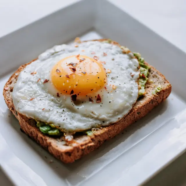 Toasted sourdough with creamy smashed avocado poached egg and red pepper flakes